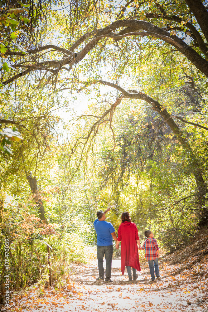 Mixed Race Caucasian and Hispanic Family Taking a Walk At The Park. Mixed Race Caucasian and Hispanic Family Taking a Walk At The Park.