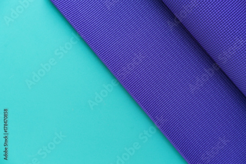 yoga mat on green background, fitness healthy and sport concept