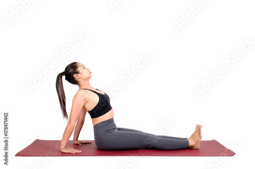 young asian woman doing yoga in Purvottanasana or Upward Plank yoga pose on the mat isolated on white background, exercise fitness, sport training, healthy lifestyle concept