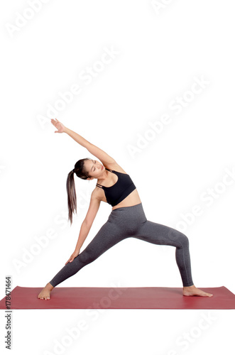 young asian woman doing yoga in Viparita Virabhadrasana or Reverse Warrior yoga pose on the mat isolated on white background, exercise fitness, sport training, healthy lifestyle concept