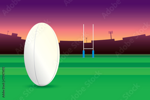 Rugby ball isolated on green field and stadium on purple sky background.