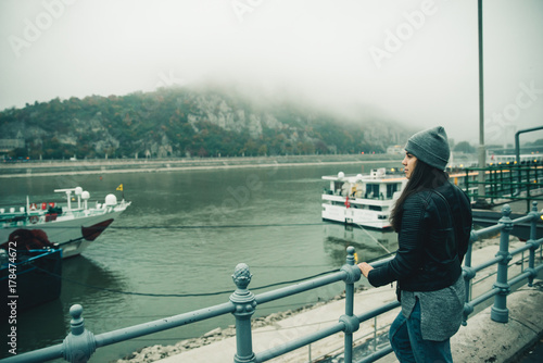 woman at city dock in foggy day