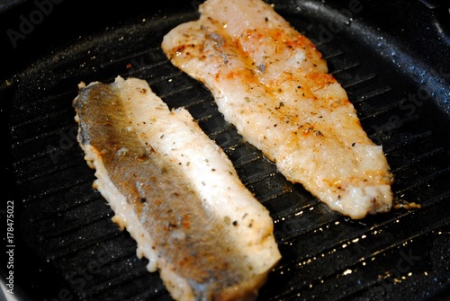 Canvas Print Fish hake cooked in a grill pan at home. Grilled fish