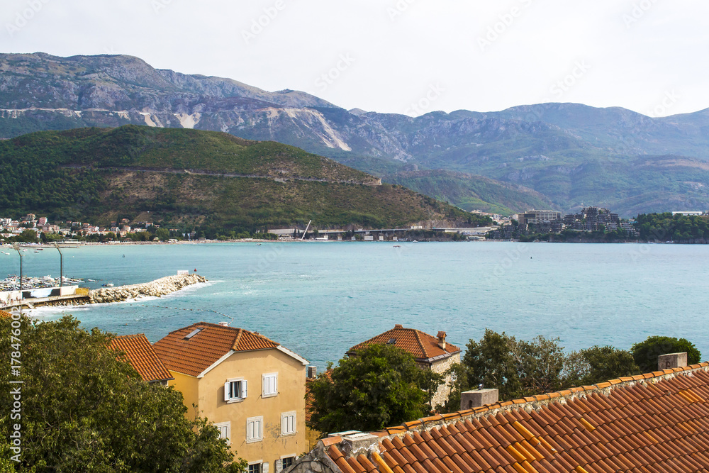 Landscape of Old town Budva: Ancient walls and red tiled roof. Montenegro, Europe.