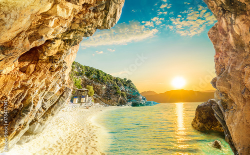Fototapeta Naklejka Na Ścianę i Meble -  Beautiful sunrise reflected in the Ionian sea and the beach in Corfu, in the summertime, Europe