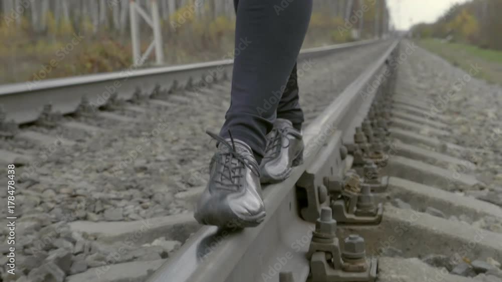 Woman Walking In Equilibrium Over Railroad Woman Walking In Equilibrium Over Railroad
