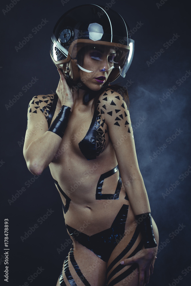woman with motorcycle helmet, naked girl dressed with black ribbons by the  body. concept speed and security Stock Photo | Adobe Stock