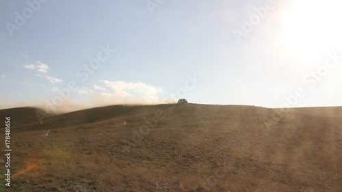 car quickly rushes on the dusty road photo