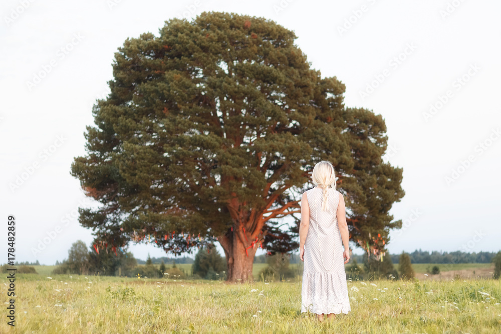 woman in front of the big tree in the park vintage style in concept lonely , alone nature green earth woman in front of the big tree in the park vintage style in concept lonely , alone nature green earth