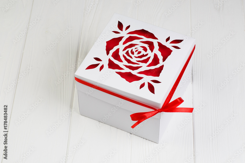 Fototapeta premium White gift box with red ribbon bow. Boxing day