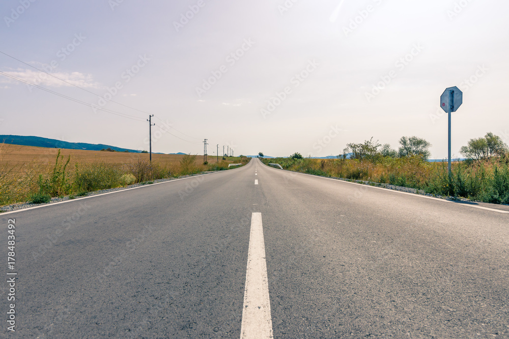Fototapeta premium Asphalt road receding into the distance.