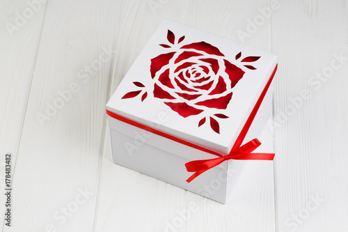 White gift box with red ribbon bow. Boxing day photo