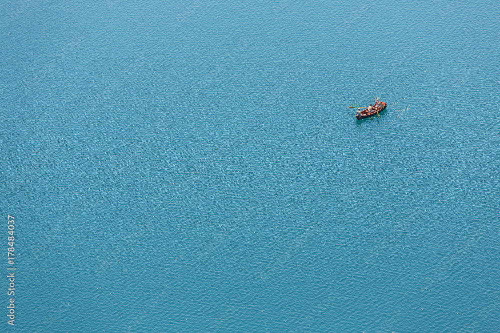 Fototapeta premium The boat sails on the lake. Aerial view
