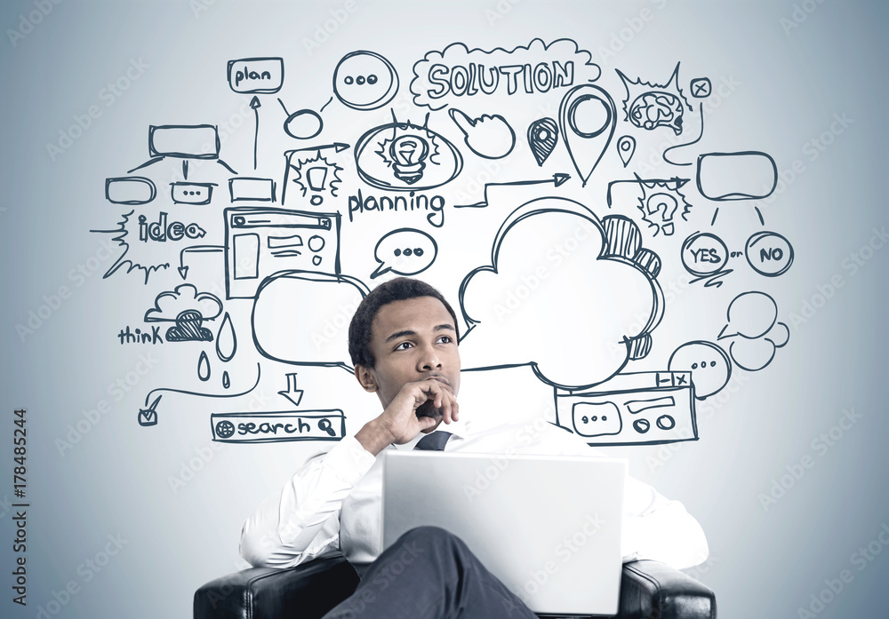 African American man with laptop, business plan African American man with laptop, business plan