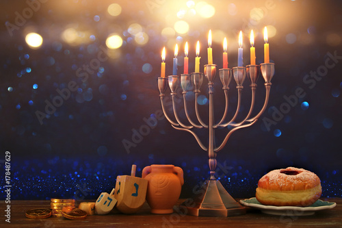 image of spinnig top, menorah (traditional candelabra) and burning candles