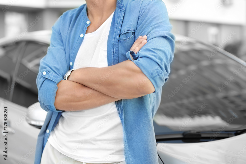 Man in casual clothes standing near car Man in casual clothes standing near car