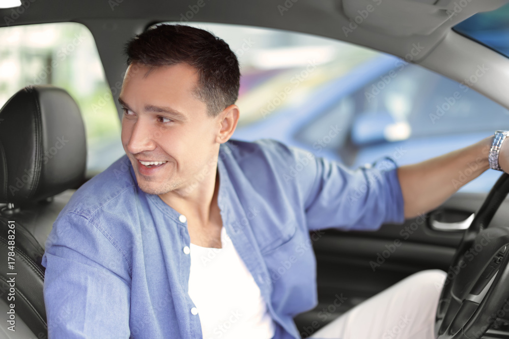 Handsome man driving a car