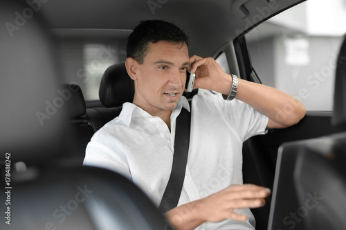 Businessman talking on phone in car © Africa Studio