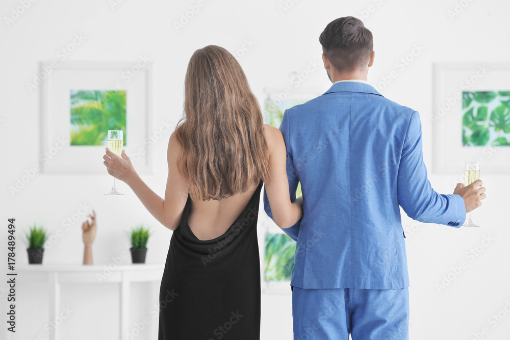 Couple in formal wear at art gallery exhibition Couple in formal wear at art gallery exhibition