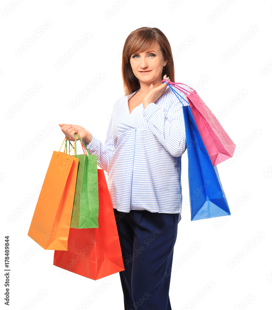 Attractive mature woman with shopping bags on white background Attractive mature woman with shopping bags on white background
