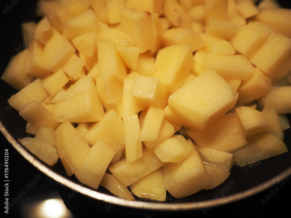 fried potatoes in a frying pan fried potatoes in a frying pan