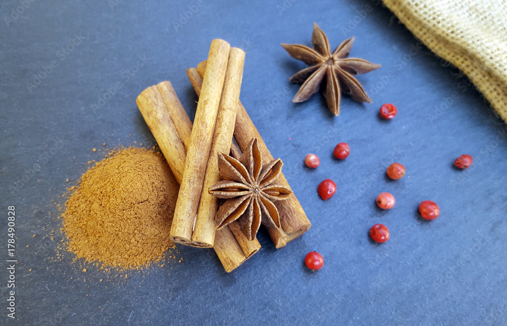 Star anise, cinnamon sticks and powder with red pepper on the table Star anise, cinnamon sticks and powder with red pepper on the table