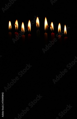 low key image of jewish holiday Hanukkah background with burning candles