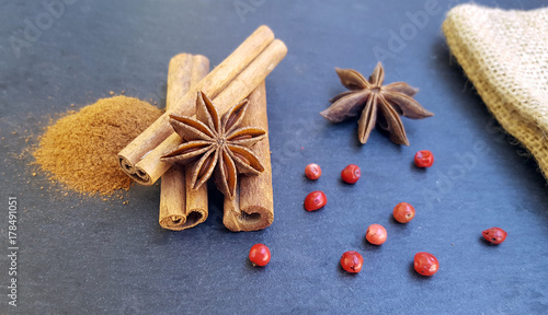 Star anise, cinnamon sticks and powder with red pepper on the table