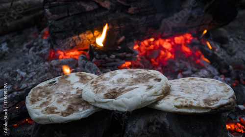 breads warming in campfire