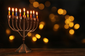 jewish holiday Hanukkah background with menorah (traditional candelabra) and burning candles