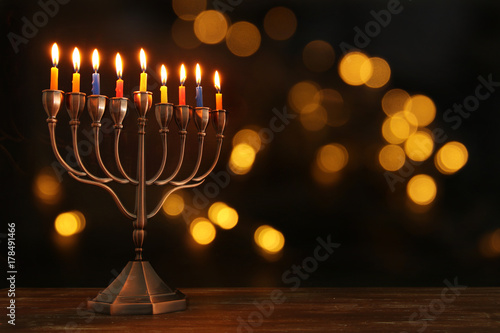 jewish holiday Hanukkah background with menorah (traditional candelabra) and burning candles