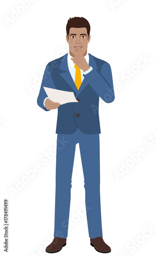 Businessman holding a paper and making hush sign