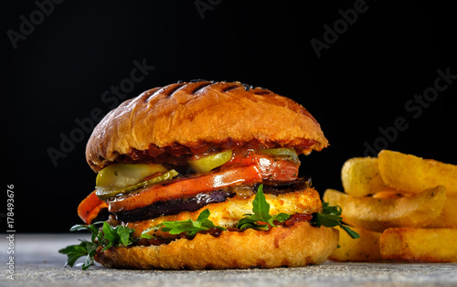 Fresh juicy delicious homemade burger. Hamburger with meat and fresh herbs.