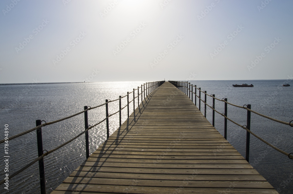 The pier leaving far into the sea
