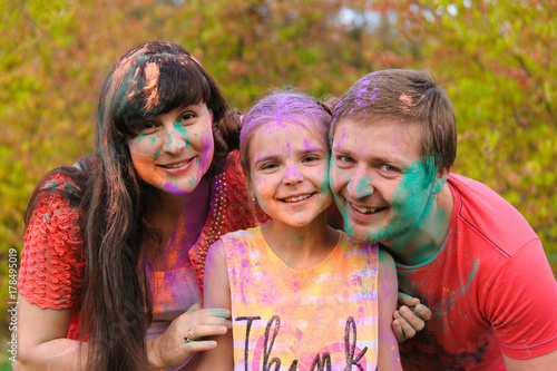 Happy family with holi painted faces