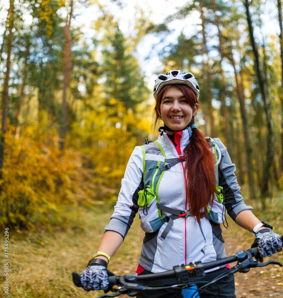 Image ofa girl in helmet riding bicycle Image ofa girl in helmet riding bicycle