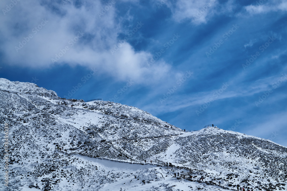 People on a tourist route in winter in the Giant Mountains in Poland. People on a tourist route in winter in the Giant Mountains in Poland.