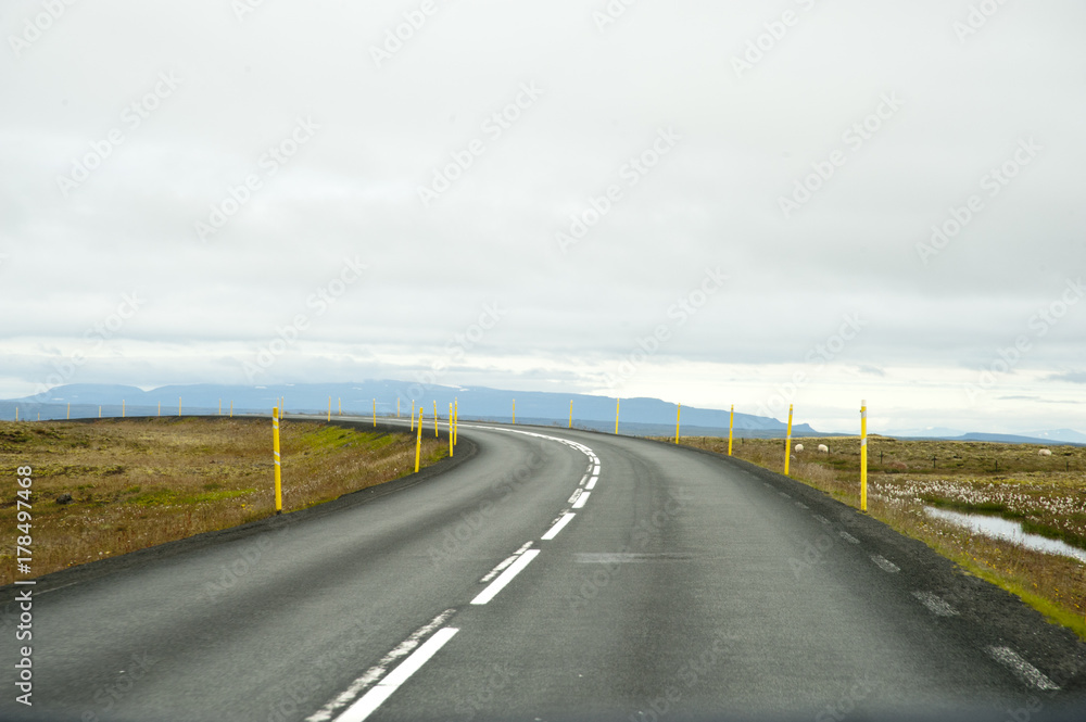 Road in a typical Icelandic landscape, a wild nature of rocks and shrubs, rivers and lakes. Road in a typical Icelandic landscape, a wild nature of rocks and shrubs, rivers and lakes.