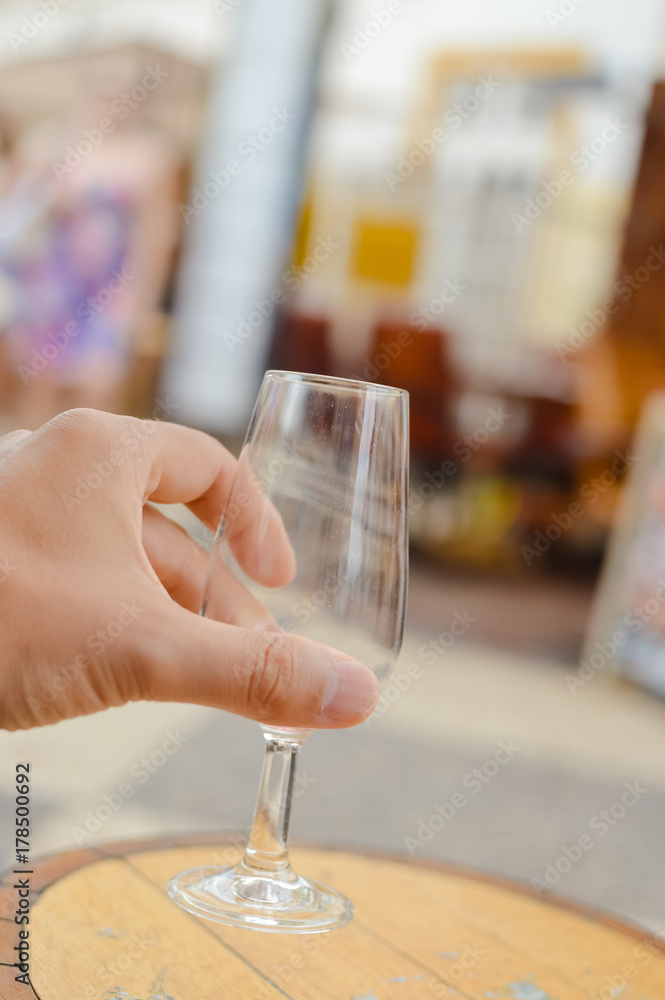 Close up on hand holding mobile smartphone and winetasting restaurant background. Modern internet connection networking, texting online luxury lifestyle