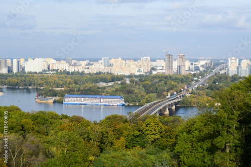 Bridge, ship, houseboat in the background of the city of Kiev. photo