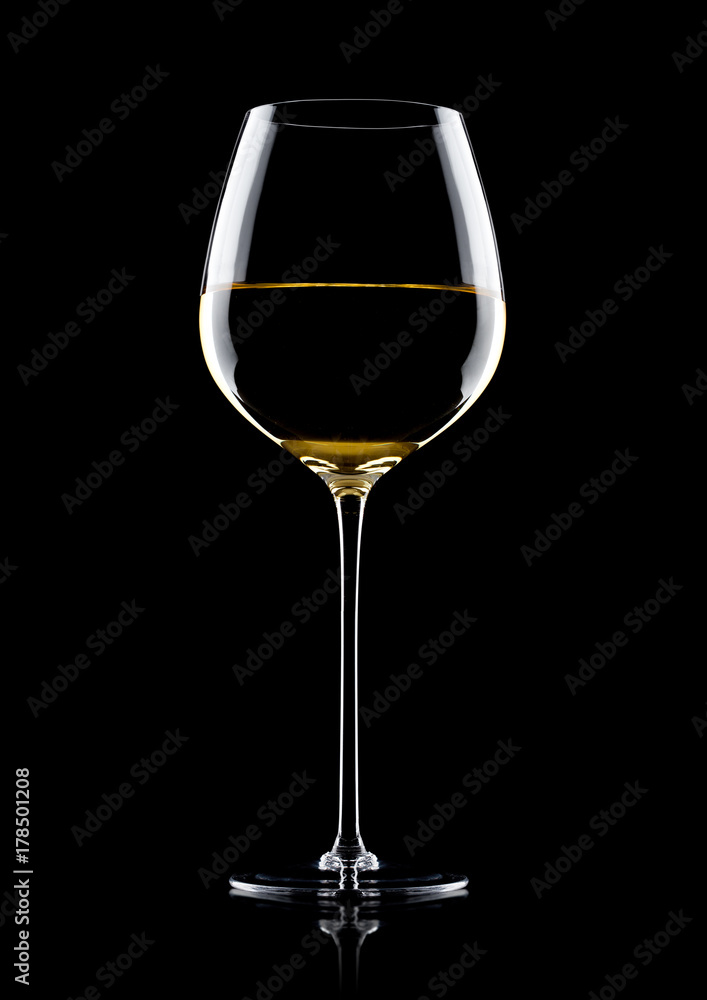 Glass of white wine with reflection on black Glass of white wine with reflection on black