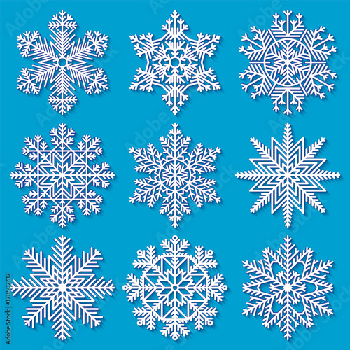 Set of white highly detailed geometrical snowflakes on blue background. Vector illustration