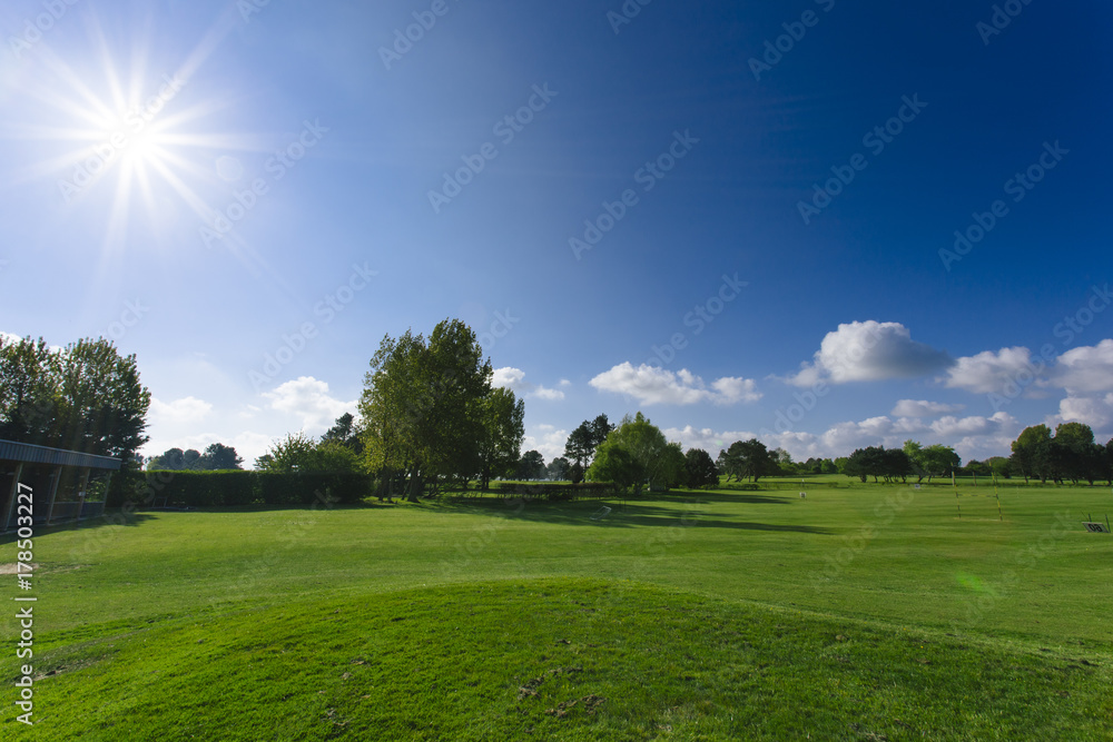 General view of a green golf course on a bright sunny day. Idyllic summer landscape. Sport, relax, recreation and leisure concept General view of a green golf course on a bright sunny day. Idyllic summer landscape. Sport, relax, recreation and leisure concept