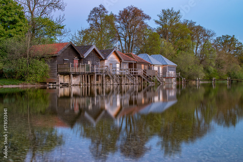 Fishermans's hut in a row with reflections