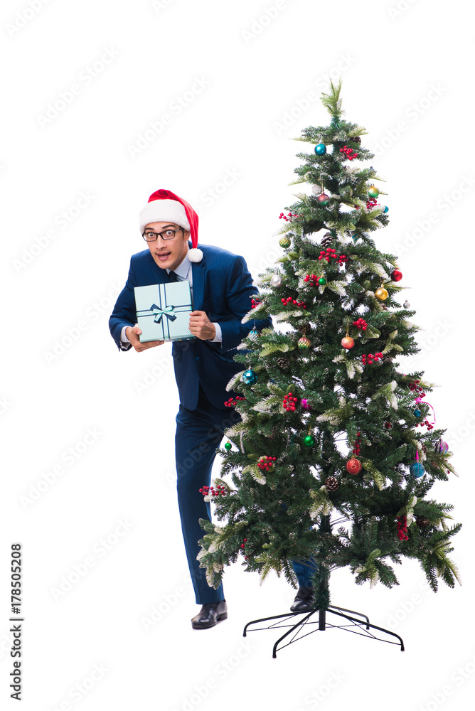 Businessman decorating christmas tree isolated on white Businessman decorating christmas tree isolated on white
