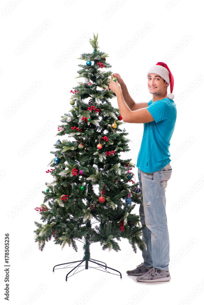 Young man decorating christmas tree isolated on white Young man decorating christmas tree isolated on white