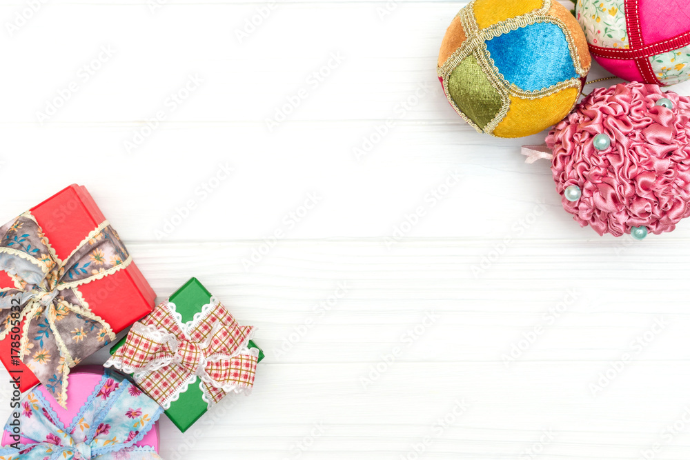 Gift boxes and New Year ornaments and toys on white wooden background - obrazy, fototapety, plakaty 