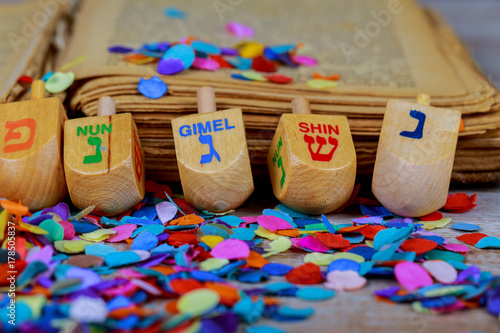 wooden dreidels spinning top for hanukkah jewish holiday over glitter background