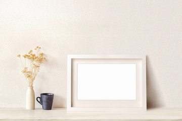Mock up poster or photo frame and vintage vase flowers and black coffee mug. Interior vintage style.