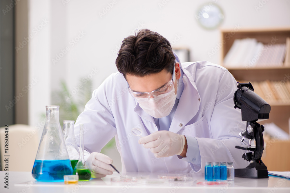 Male doctor working in the lab on virus vaccine Male doctor working in the lab on virus vaccine